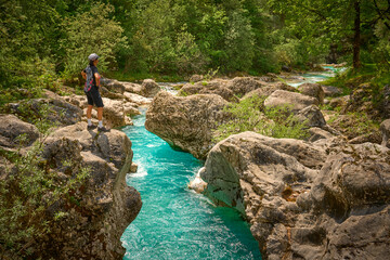 woman resting during a hiking tour along turquoise River Soca in the Triglav National Park of the...