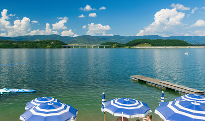 Beach on the Bilancino lake with view of the dam and the bridge, Tuscany