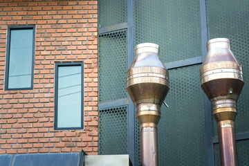 Metal ventilation pipeline and air circulation system of the classic style brickwork building. 