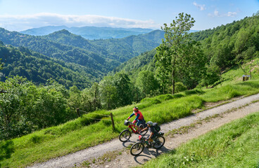 Obraz premium active senior couple on a bike tour with their electric mountain bikes in the Karst Mountains of Slovenia near Solkan