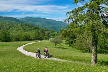 Fototapeta na wymiar active senior couple on a bike tour with their electric mountain bikes in the Karst Mountains of Slovenia near Solkan