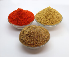Close up of three basic, main and essential ingredients or spices of Indian/Asian food. Coriander powder, Garam masala and the spicy Red chili powder.