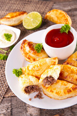 Homemade stuffed beef empanadas and spicey dipping sauce