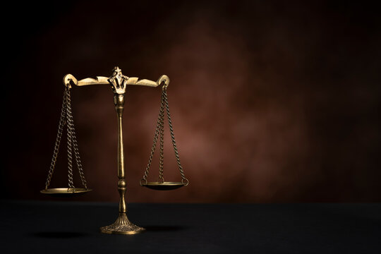 scales of justice on brown background