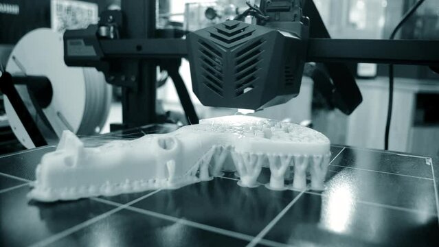 3D printer. 3D printer printing process close-up. 3D printer creating object from molten plastic. 3D printing. Innovation additive robotic technology. Modern three-dimensional printing technologies