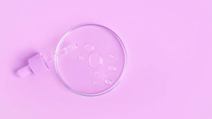 Cosmetic pipette with gel, serum and serum in a Petri dish on a pink background
