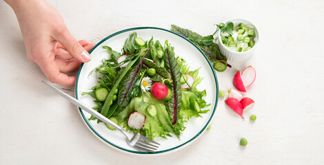 Fresh vegetarian vegetable salad with radish, cucumber and arugula, healthy food.