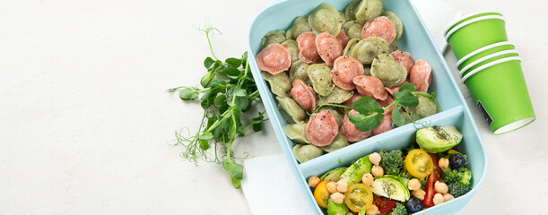 Vegetarian food. Colored dumplings in a plate/on board.