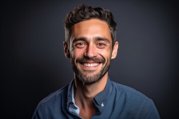 Obraz premium Headshot portrait photography of a satisfied boy in his 30s giving a hug to the camera against a deep indigo background. With generative AI technology