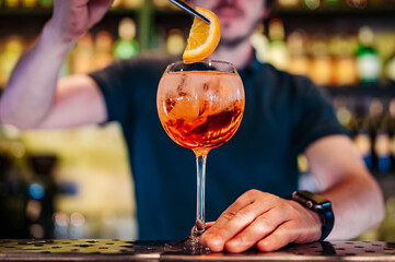 man hand bartender making cocktail in glass on the bar counter