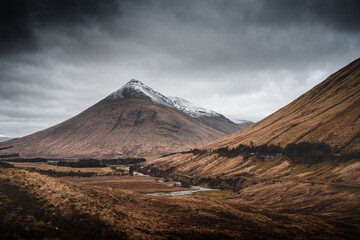 A snow capped mountain in Scotland, Beinn Dorain with cloudy sky