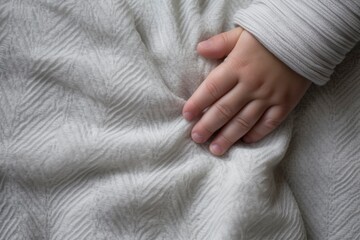 Close up of baby hand , fat and cute baby hand, blanket background. Concept of love and family