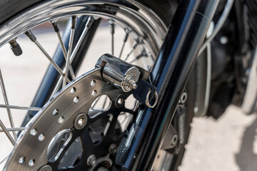 Anti-theft locking device on the motorcycle brake disc