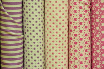 Mix fabrics. Shop counter. Many fabrics of different types. View from above. Printed, cotton, mixed jersey. For sewing clothes and bed linen.