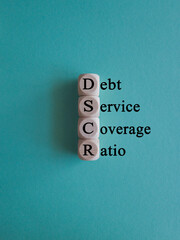 DSCR debt service coverage ratio symbol. Concept words DSCR debt service coverage ratio on wooden...