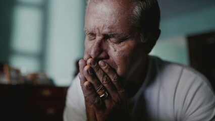 Preoccupied older man covering face in shame and anxiety. A male caucasian middle-aged person...