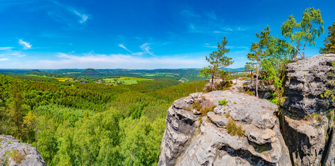 Panoramic over sandstone rocks Gohrisch Stein, Koenigstein and Lilienstein viewed from Papststein...
