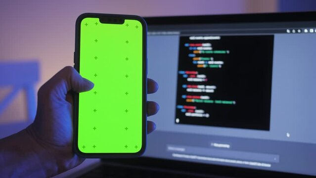 Phone with chroma key green screen with man working with chatbot AI online, connecting with AI and using a chat. IT engineer software developer programmer interact with chat bot, making