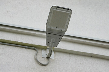 white modern led electric lighting street lamp on city building wall background on clear sunny...