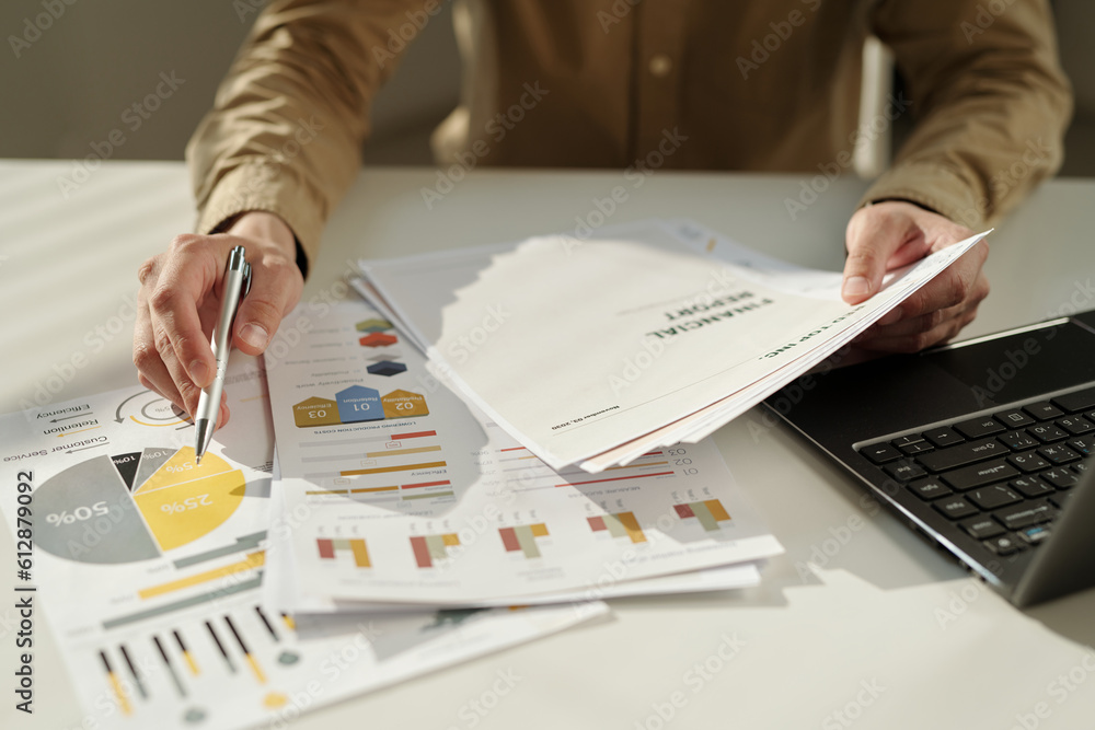 Poster Hands of young male economist making report or presentation of financial data while pointing at document with grey and yellow diagram