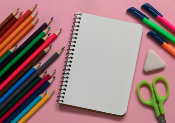 School stationery on a pink background. Top view. Copy space.
