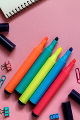 Bright colorful markers on a pink background. Top view. Copy space.