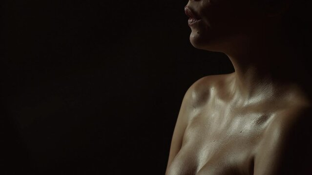 Woman during an orgasm on a black background. Sexy girl sensual lip, beauty boob. Concept of passion. Sensual woman has orgasm. Aroused girl have orgasm and screaming. Girl feels pleasure, orgasm.