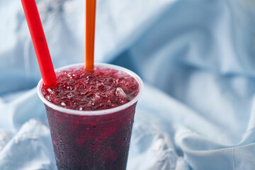 A vibrant red raspado, raspadilla or cholado ice summer treat or dessert