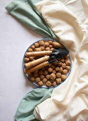 Edible Caramel Clay Stones in a round plate, with two garden shovels and wrack minimal flat lay