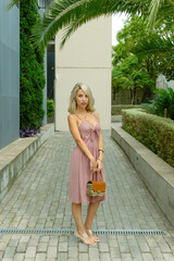 BLONDE AND HANDSOME GIRL WOMAN WITH A BAG IN THE STREET