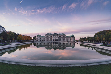 belvedere palace in Vienna at pink sunset and purple flowers - obrazy, fototapety, plakaty