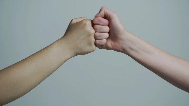 MTeam concept. Hands of man people fist bump team teamwork, success. People bumping their fists together, arms. Friendly handshake, friends greeting.
