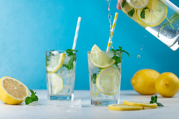Lemonade with lemon slices, ice and mint leaves