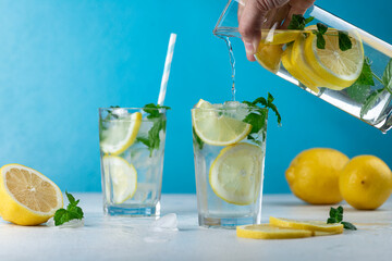 Lemonade with lemon slices, ice and mint leaves