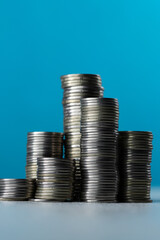 Silver coins in stacks on a blue background