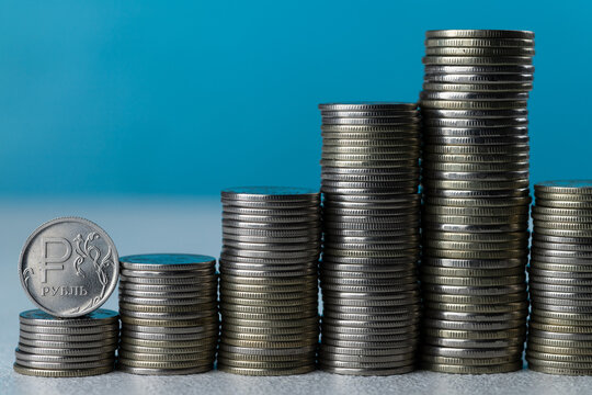 Silver coins in stacks on a blue background