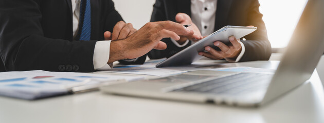 financial advisory services. Asian advisor showing plan of investment to clients in the consultancy office.