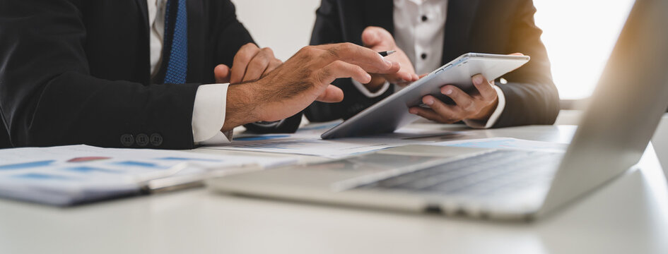 financial advisory services. Asian advisor showing plan of investment to clients in the consultancy office.