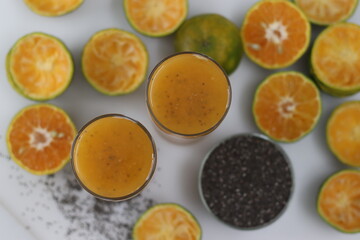 Fototapeta na wymiar Freshly squeezed orange juice with soaked chia seeds
