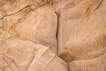 
Horizontal rock texture with curves in beach tones.