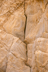 Rock texture with curves in beach tones.