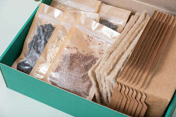 Fototapeta na wymiar Set for growing sprouts from seeds. Seeds, linen mats, boxes and lids flat lay, top view
