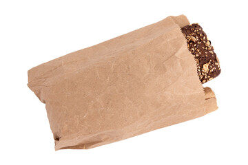 homemade freshly baked traditional rye bread in paper bag isolated on white background, top view, whole rye bread brick with crispy crust and sunflower seeds