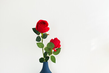 Close up of red roses in vase.