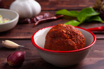 Thai red curry paste in white bowl,is a versatile and flavorful base for a variety of Thai dishes