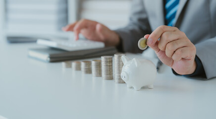 savings and finance concept. woman putting money coin in piggy bank for saving money and plan...