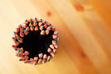 Colored pencils on wooden table © Jola