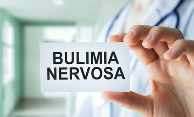 Bulimia nervosa text on notepad in hands doctor, medical concept.