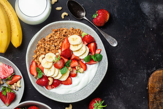 Granola with yogurt, strawberry and banana in a bowl