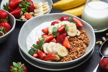 Granola with yogurt, strawberry and banana in a bowl